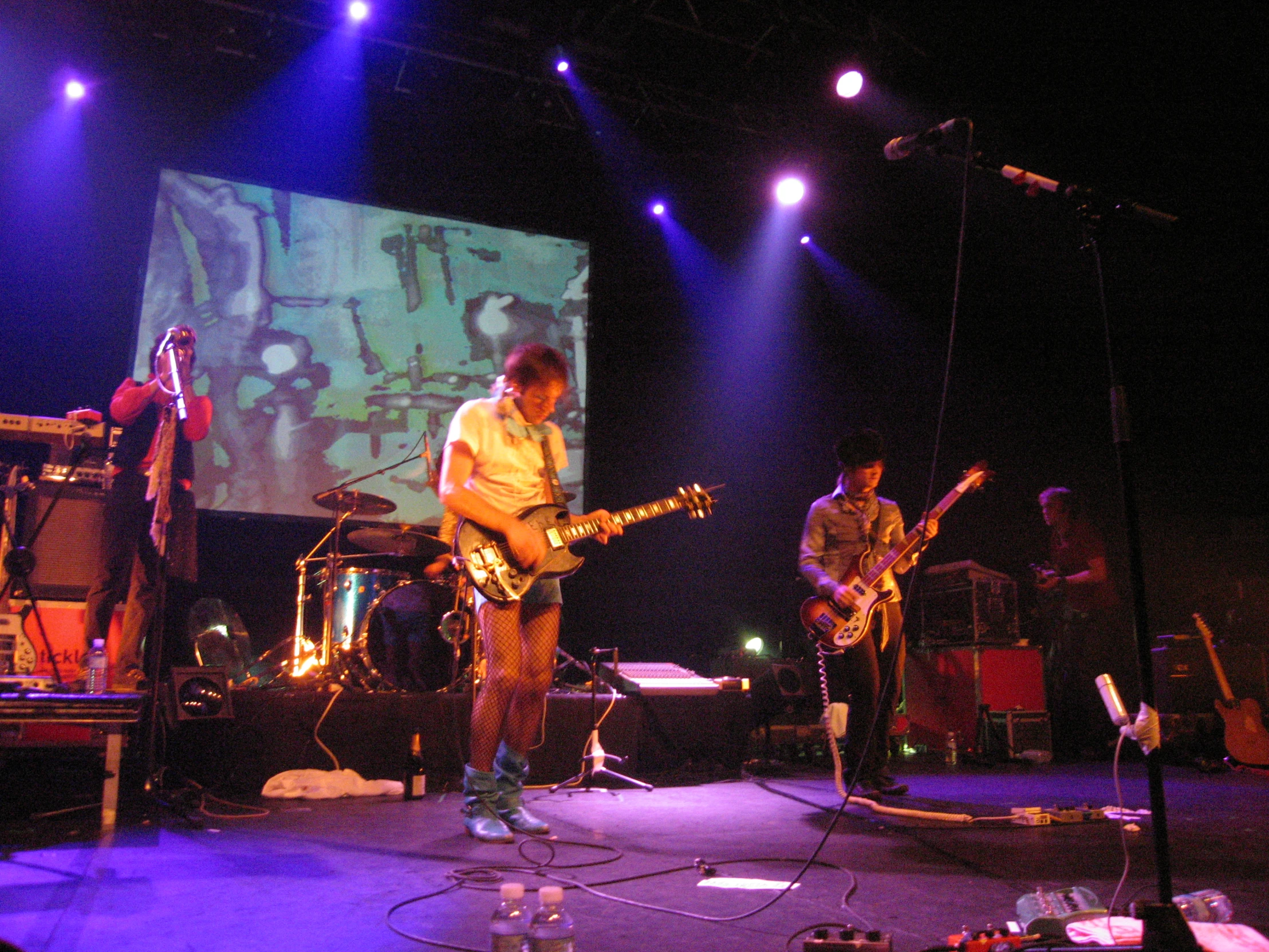 people are playing a concert on a stage