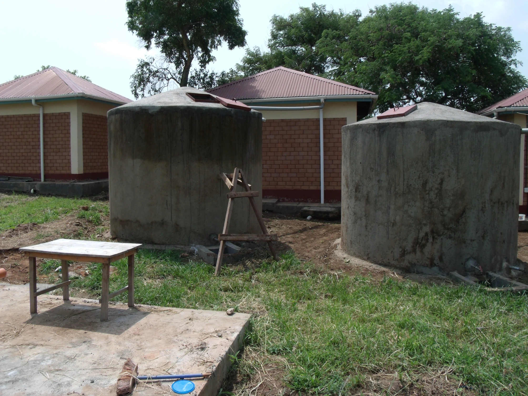 two concrete blocks on a building next to a small table and chairs