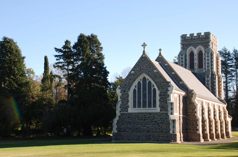 a stone church building in the middle of a park