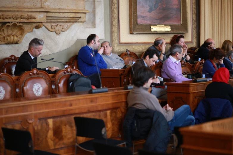 an audience sits and listens in the court