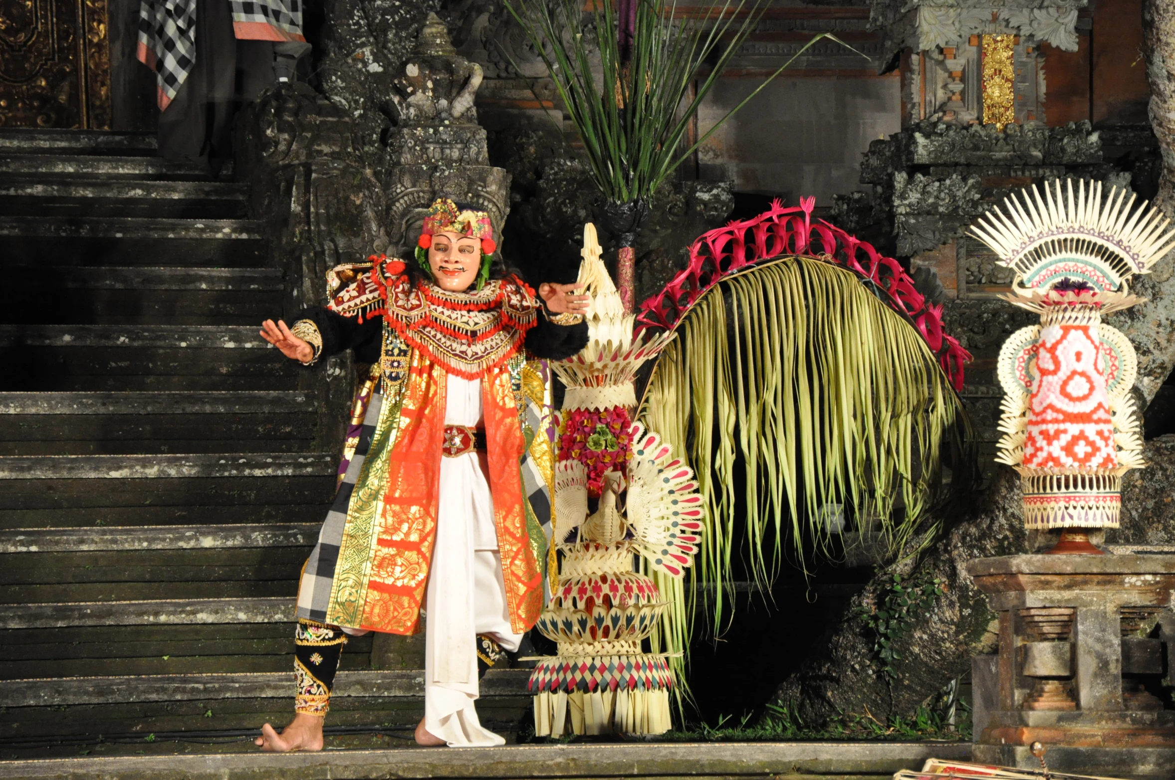 a person wearing costume standing next to a decorated stage