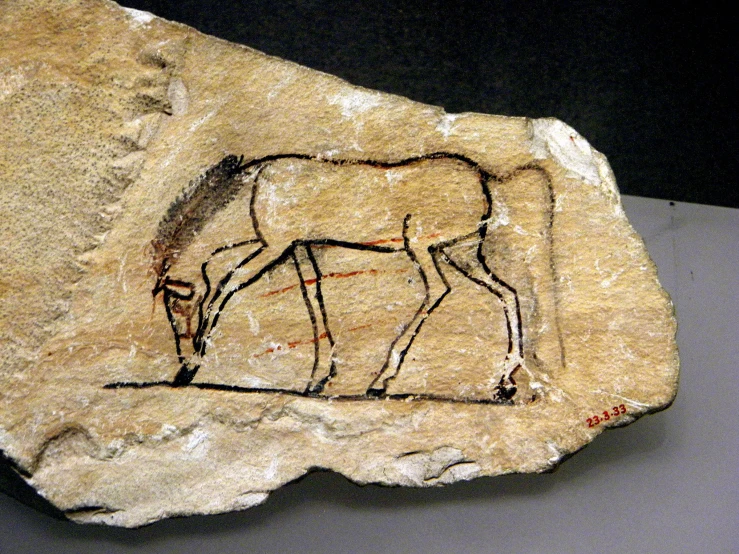 the painting on the rock depicts deers grazing