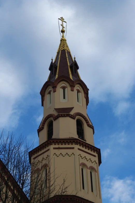 a large clock tower is up against the blue sky