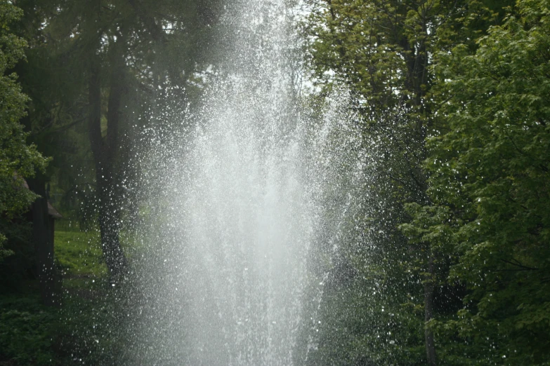 a water spewing from the top of a fountain