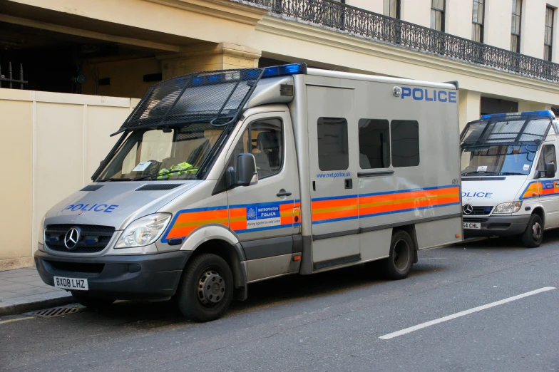 an armored ambulance parked near a street with another one in front