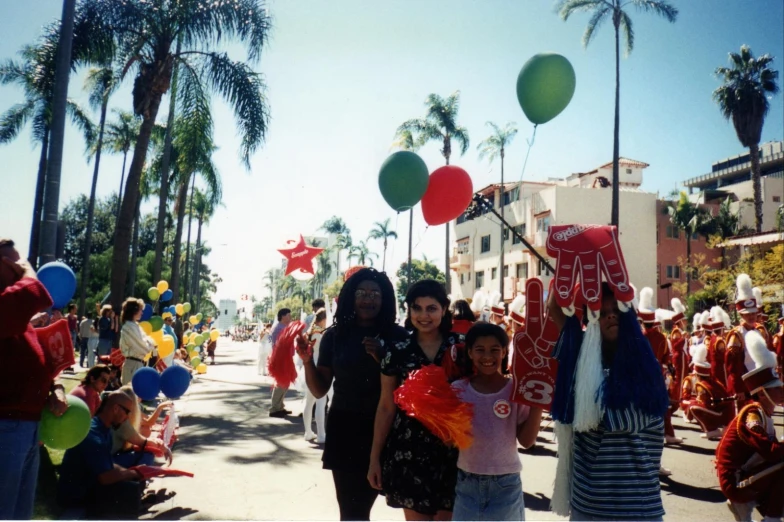 a parade with lots of people wearing colorful attire