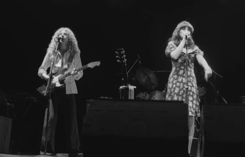 a couple of woman singing and playing guitars