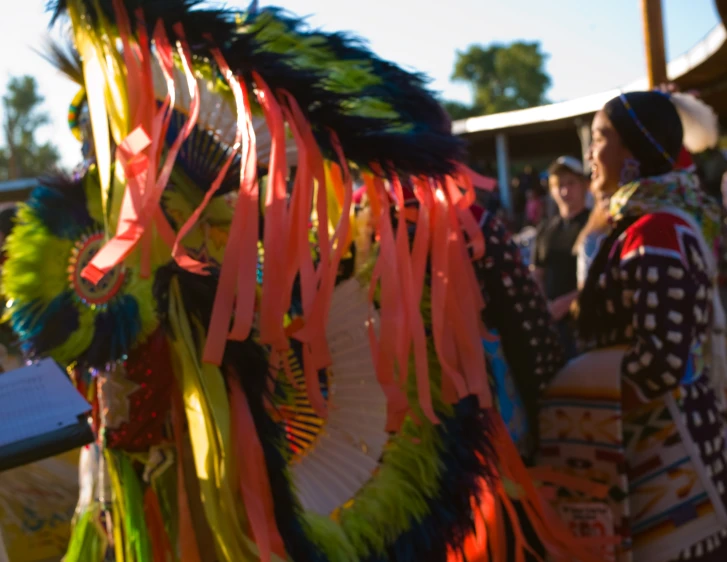 a woman is walking past a large colorful display