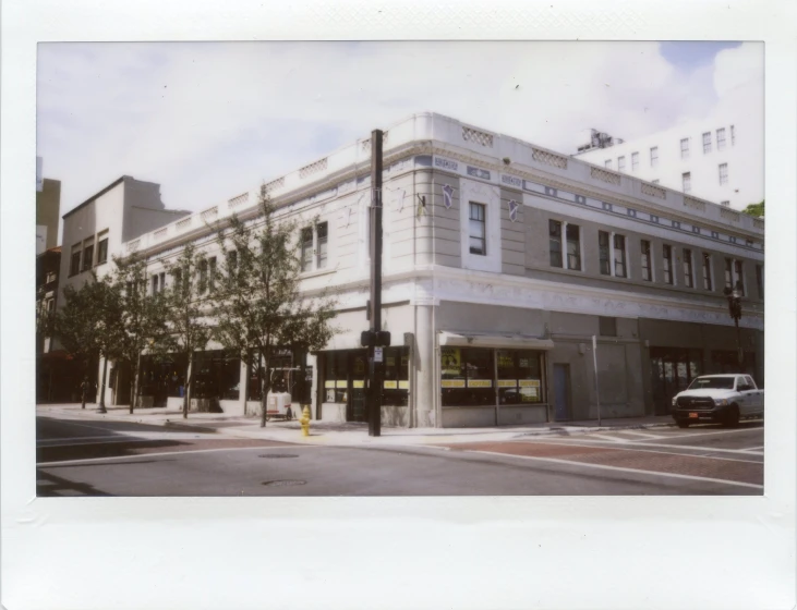 an old town building in a city with tall buildings