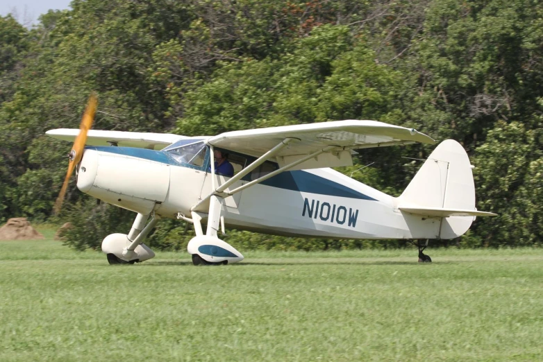 an old airplane sitting on a grass field