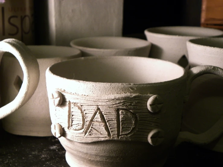 cups with the words dad are lined up