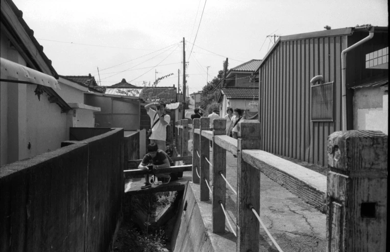 people are walking on the side of a waterway in an old po