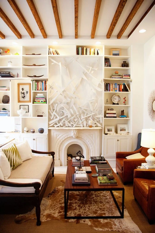 a living room with some brown furniture and bookshelves