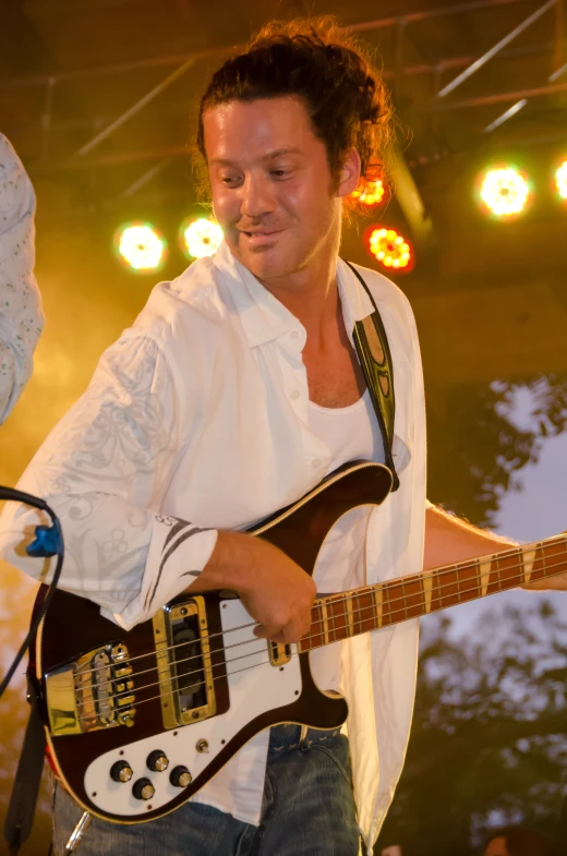 a man is playing an electric guitar on stage