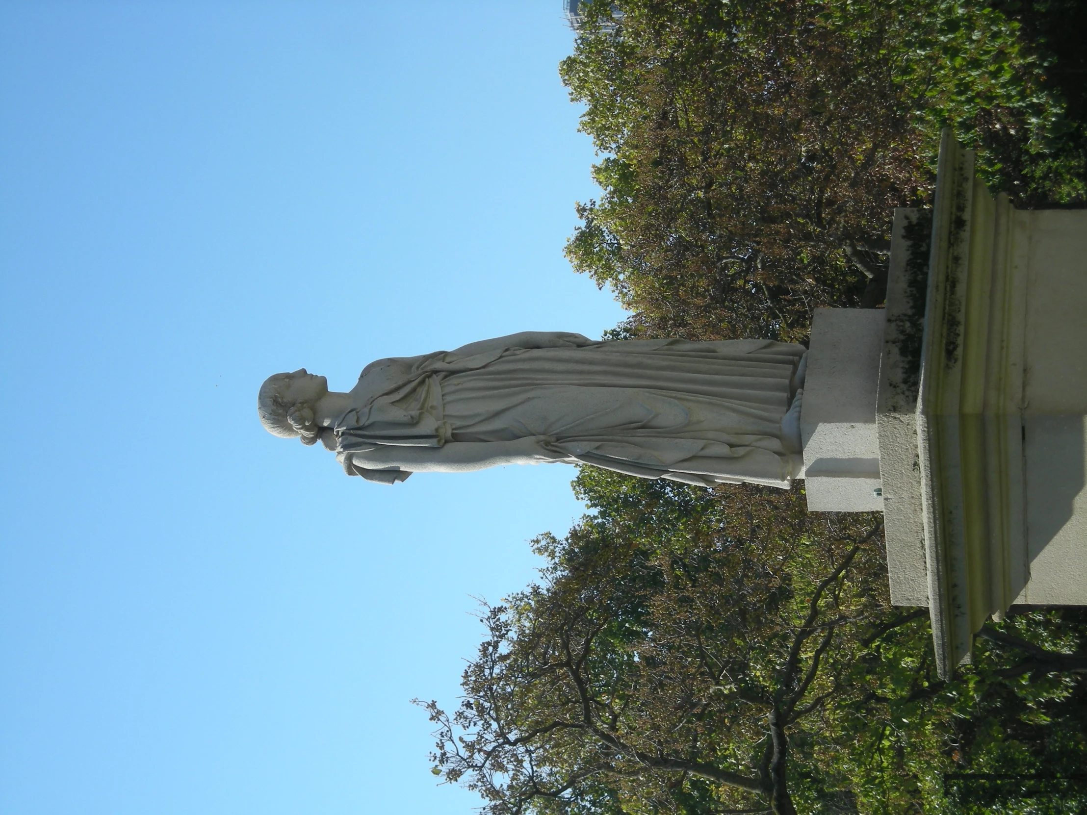 a statue that is in front of some trees