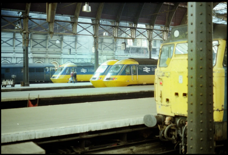 two train engines sitting beside each other at the station