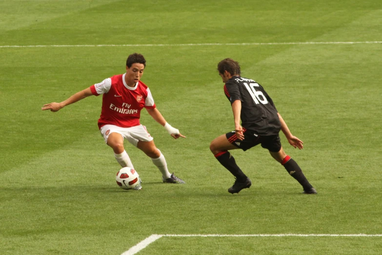 two men compete for the ball in a soccer match