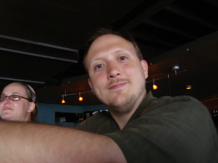 a man and woman in a restaurant and one woman has on glasses