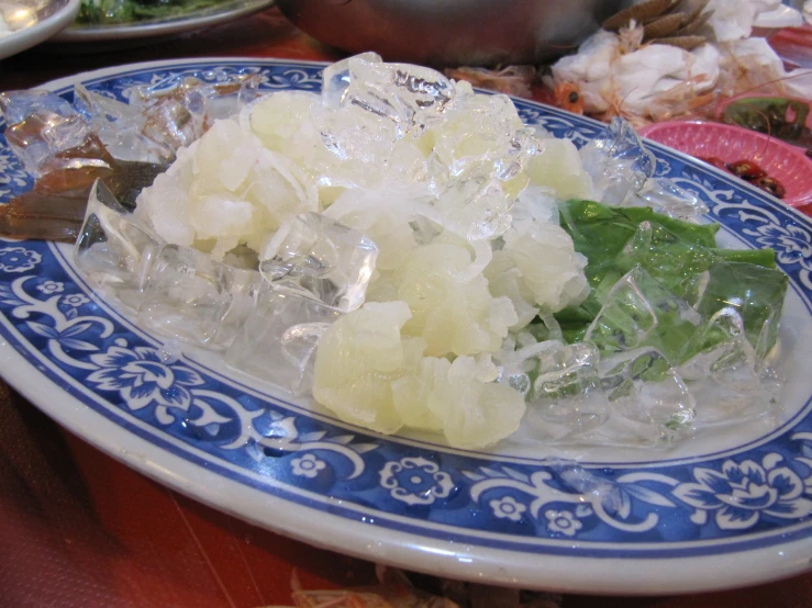 a bunch of ice cubes on a plate with spoon