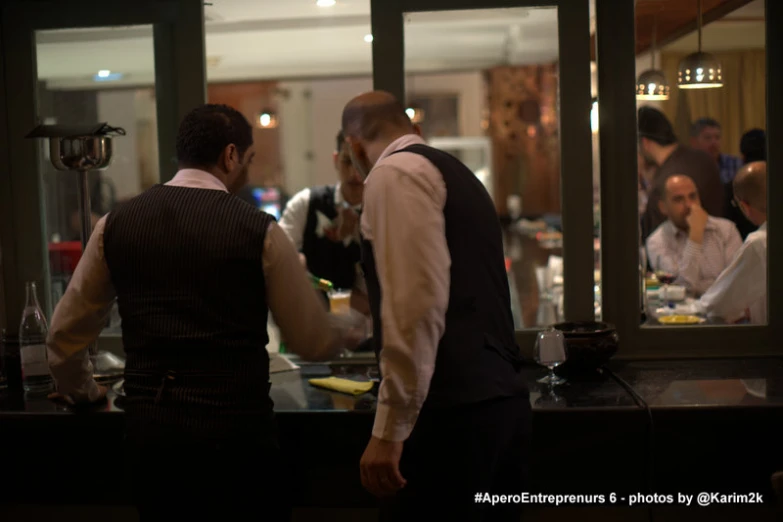 a group of people in a bar with glass doors