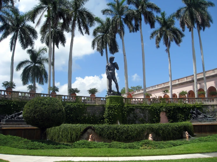 a statue of a man is in the center of a green yard