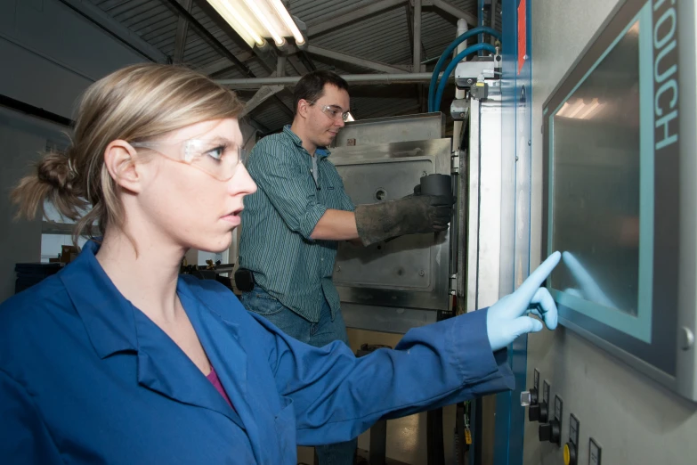 two people in a warehouse are looking at soing