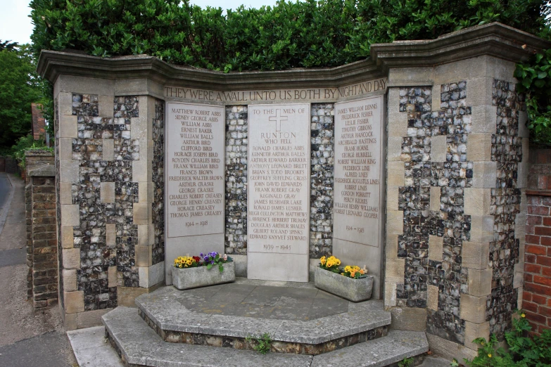 a stone monument is adorned with flowers