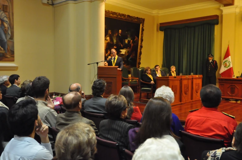 a large audience is watching a speaker in front of an audience