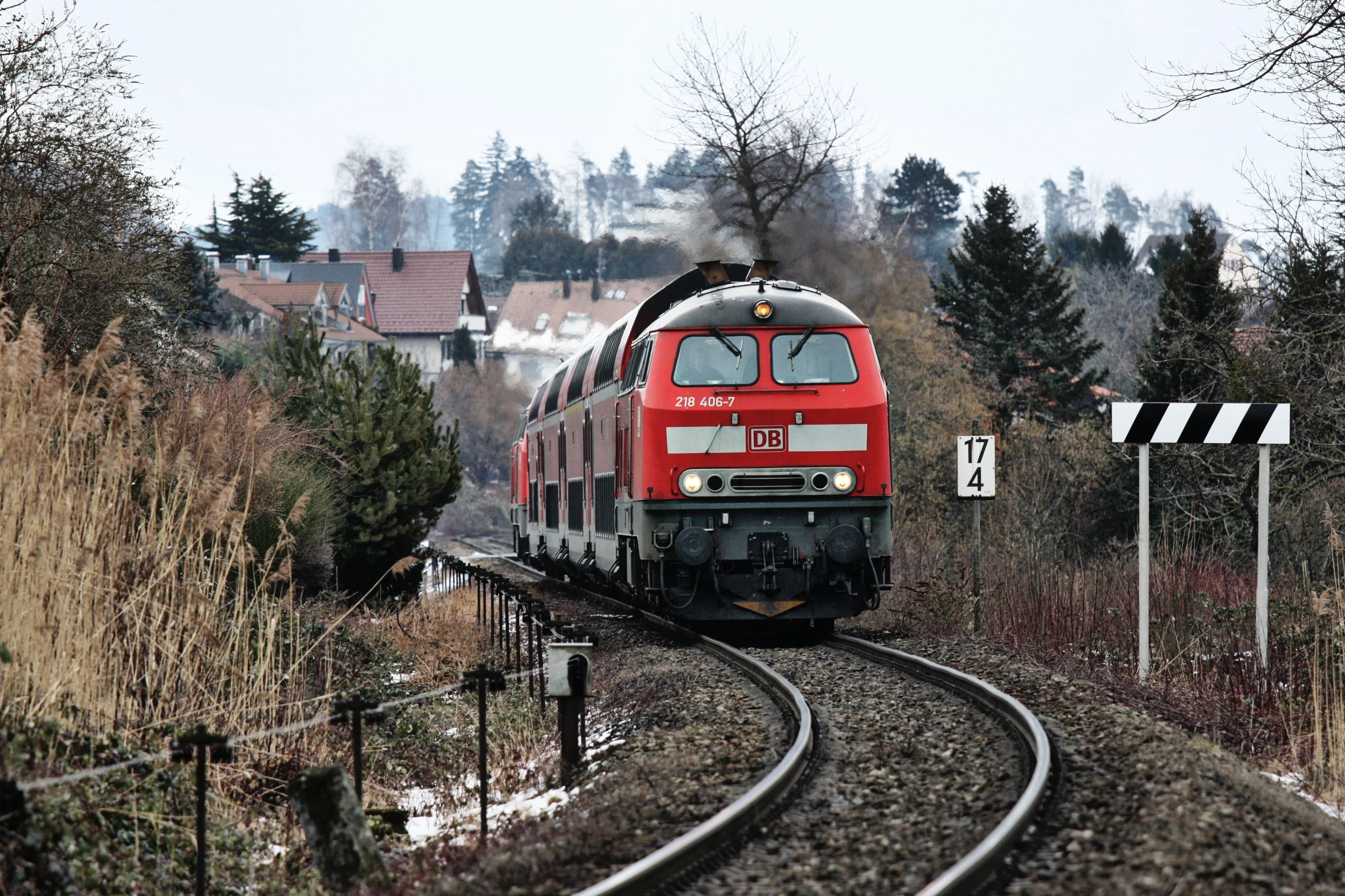 a train traveling through a rural countryside on train tracks