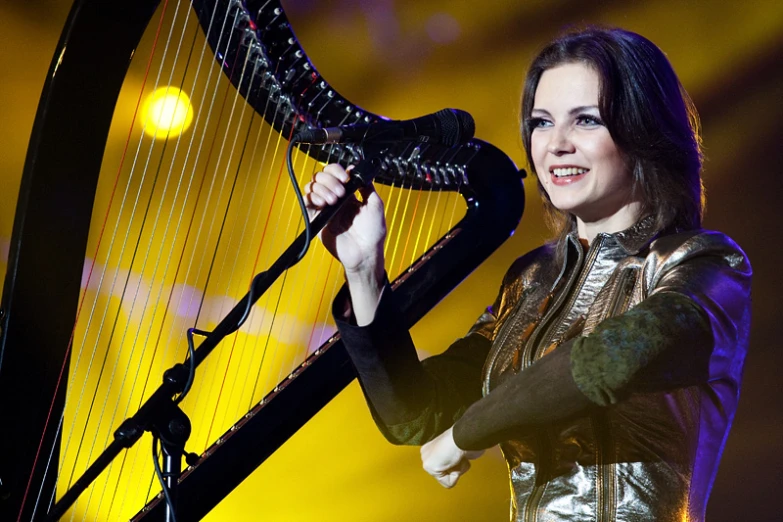 a woman with long hair playing a harp