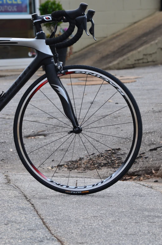 a black and white bike parked next to a curb