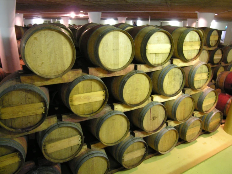 many barrels are stacked on a wall