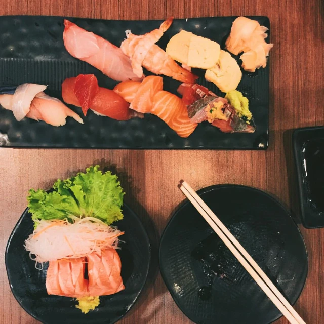 two plates with some sushi on them