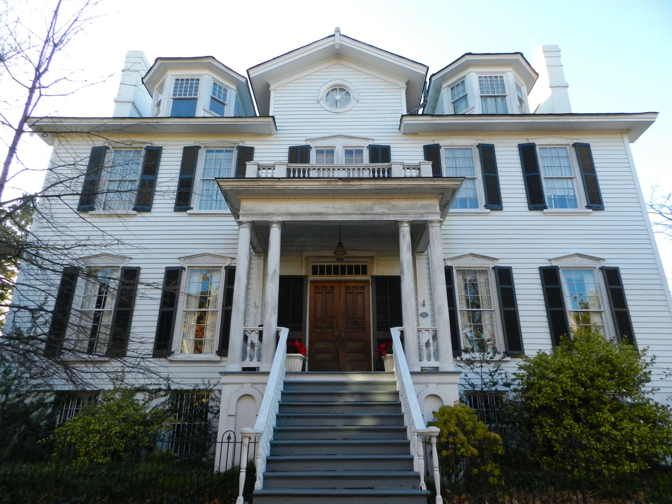 a large white house with steps leading up to the door