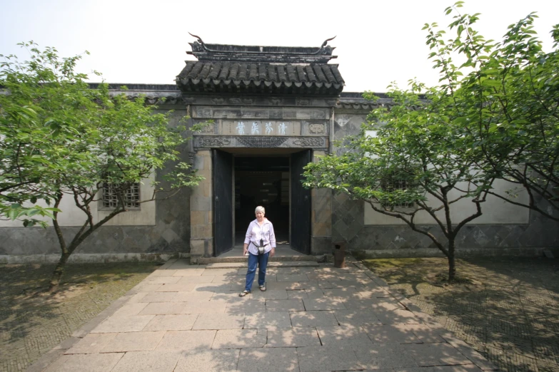 an older gentleman standing at the entrance to a building