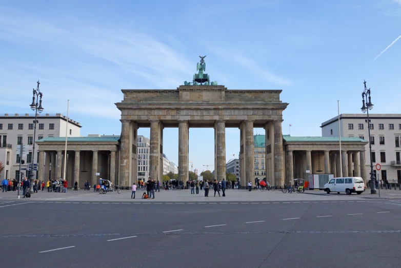 a bunch of people standing outside a gate that is built into the ground