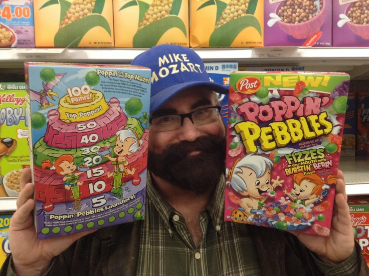 a man holding a box of poppin pebbles in front of him