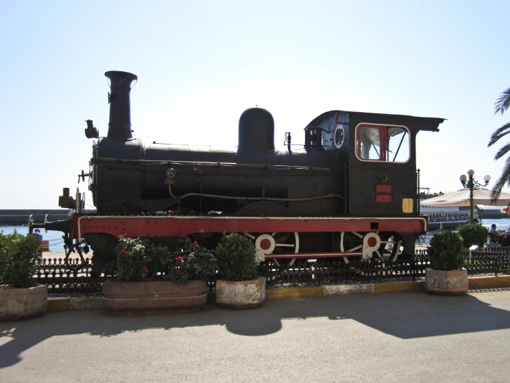 an old train on display near some trees