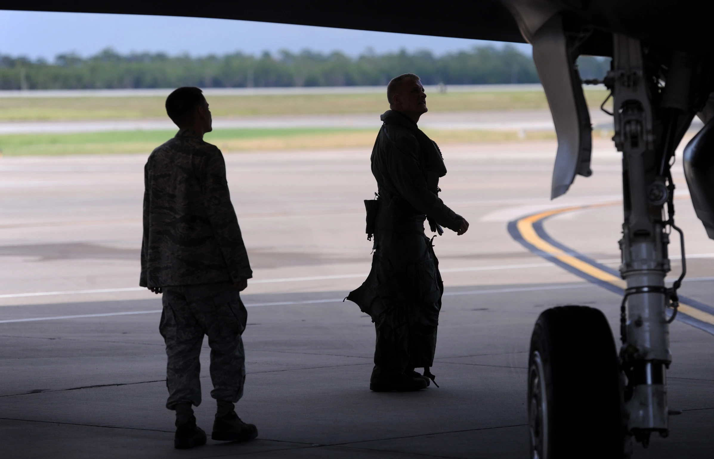 two soldiers standing by the door of an airplane