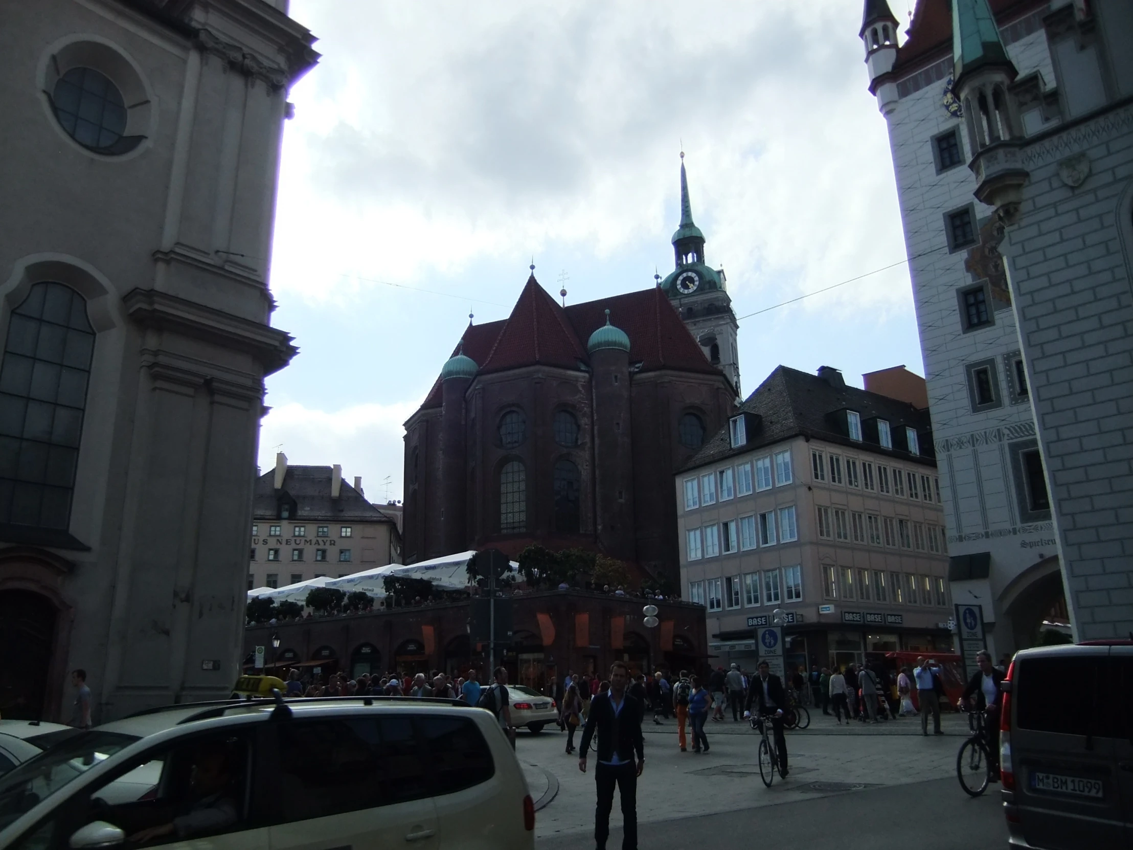 people are standing outside near large buildings