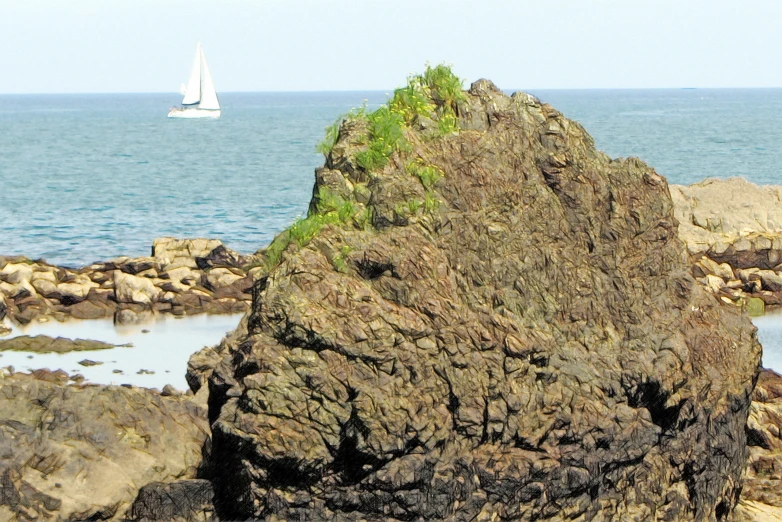 a very big rocks by the water with a sail boat in the background