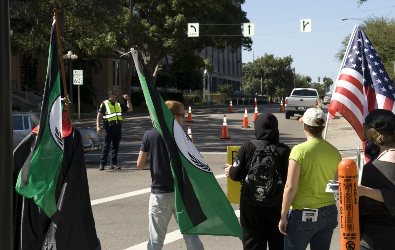 a group of people are walking along the street