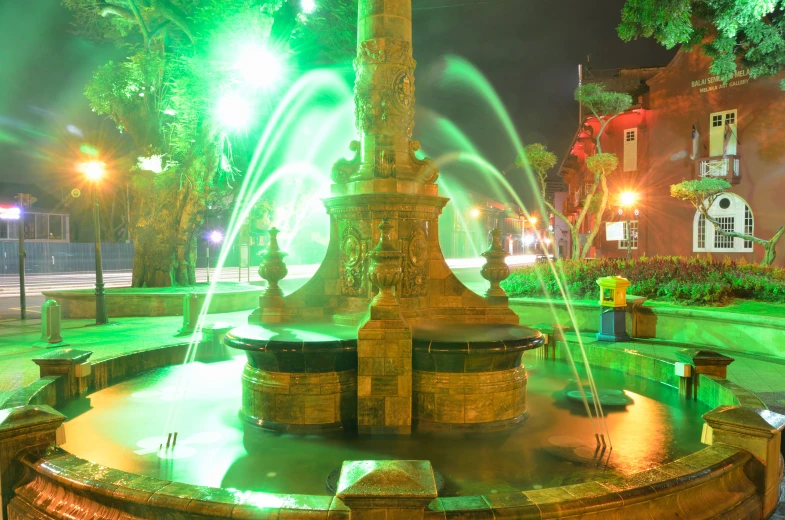 fountains show up from the light in a park