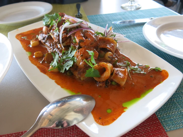 a meal consisting of meat and vegetables in sauce