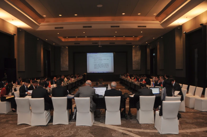 an event is set up with people sitting at tables and facing a screen