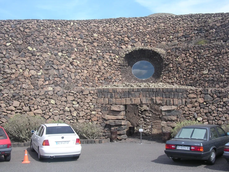 the building is made of rocks and has a circular hole