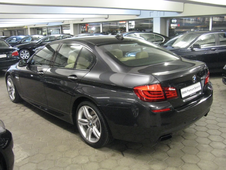 a large black car is parked in an underground garage