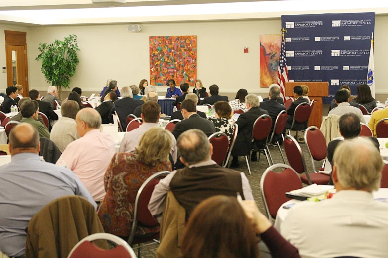 a large room filled with people watching another presentation