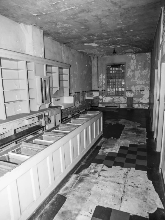 black and white pograph of old - fashioned kitchen