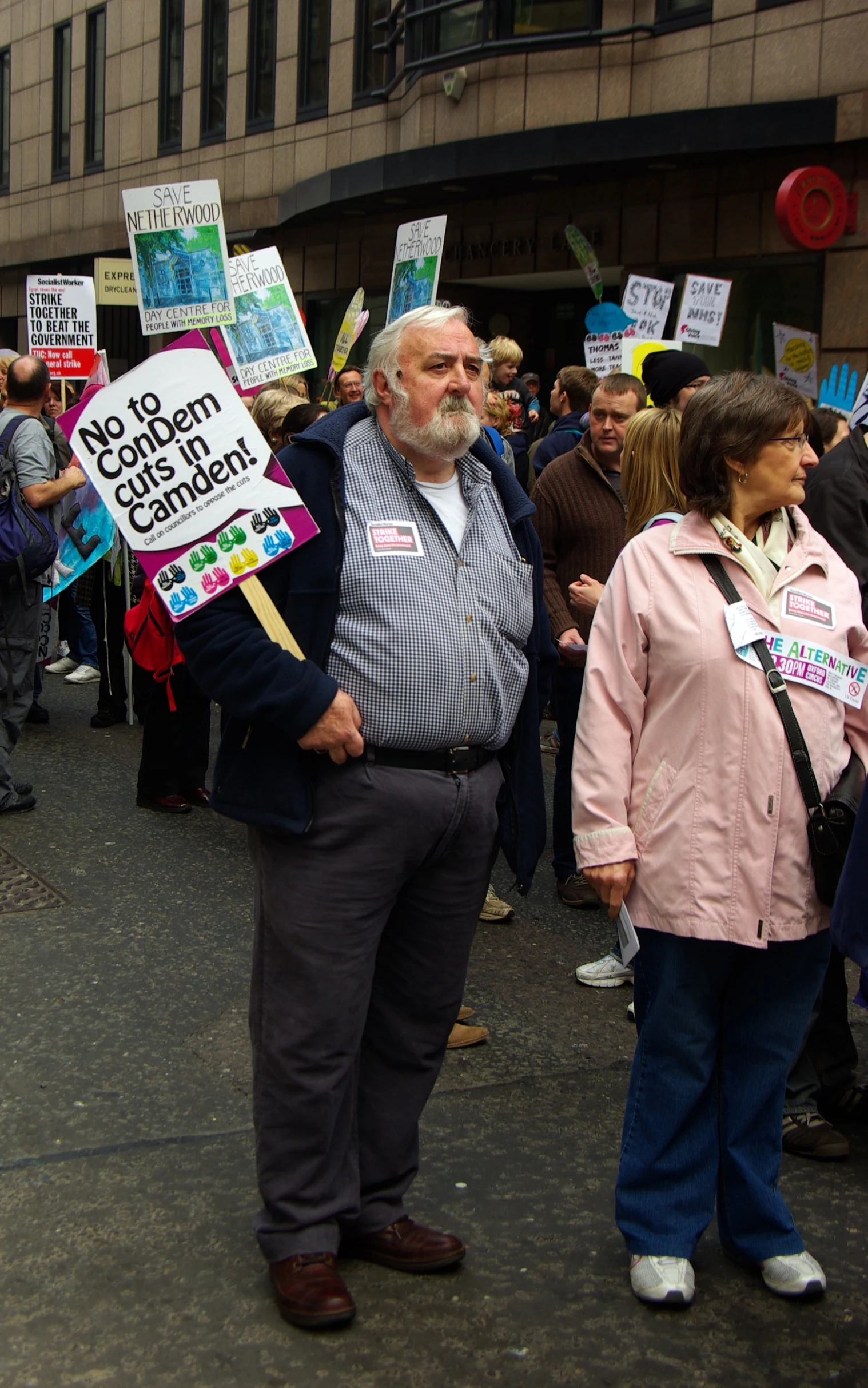 many people standing in a row with signs on them